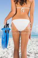 Perfect feminine buttocks of slim young woman holding fins