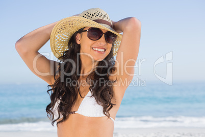 Cheerful attractive brunette with straw hat and sunglasses