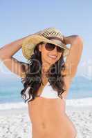 Happy attractive brunette with straw hat and sunglasses