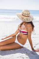 Young tanned woman wearing straw hat relaxing