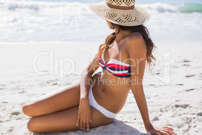 Young sexy woman wearing straw hat relaxing