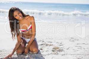 Smiling young woman in swimsuit posing