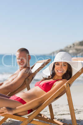 Couple on their deck chairs smiling at camera