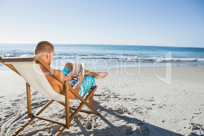 Smart handsome man reading a book