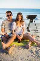 Cheerful couple posing while having barbecue