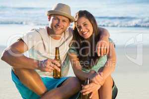Smiling couple embracing while having a drink together