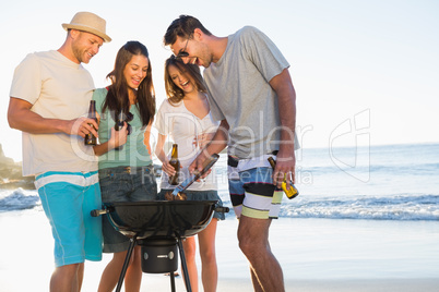 Smiling young friends having barbecue together