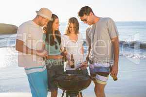 Cheerful young friends having barbecue together