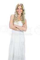 Smiling attractive model in white dress posing