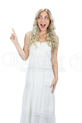 Astonished attractive model in white dress posing