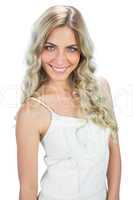 Smiling sensual model in white dress posing