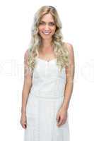 Cheerful seductive model in white dress posing