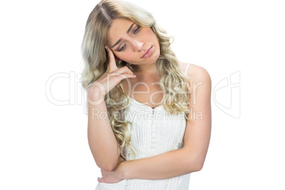 Sad seductive model in white dress posing