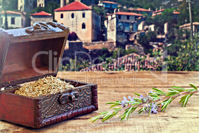 Fresh and dried rosemary on rustic wooden table with old country