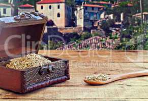 Dried rosemary on rustic wooden table with old countryside villa