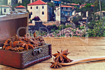 Star anise spice on rustic wooden table with old countryside vil