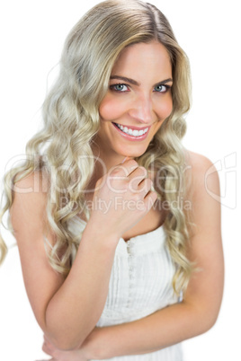 Cheerful curly haired blonde smiling