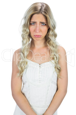 Upset curly haired blonde posing