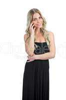 Content attractive blonde with black cocktail dress posing