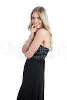 Attractive blonde wearing black dress biting her finger nail
