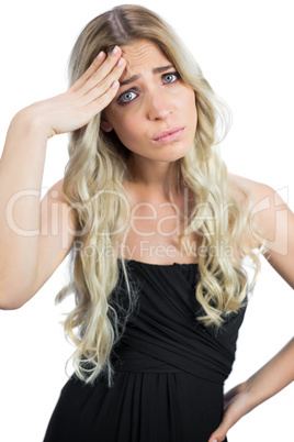 Gorgeous blonde wearing black dress suffering from headache