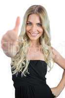 Smiling gorgeous blonde in black dress thumbs up