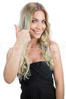 Cheerful gorgeous blonde in black dress thumbs up