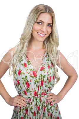 Smiling blonde wearing flowered dress posing