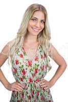 Smiling blonde wearing flowered dress posing