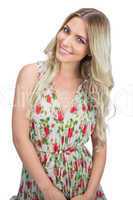 Cheerful attractive blonde wearing flowered dress posing