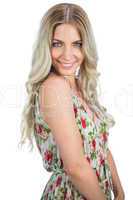Happy attractive blonde wearing flowered dress posing