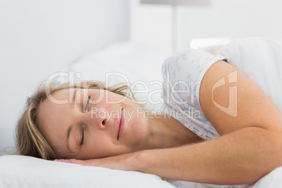 Peaceful blonde woman sleeping in bed