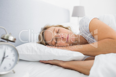 Blonde woman sleeping in bed peacefully