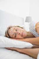 Blonde woman asleep in bed