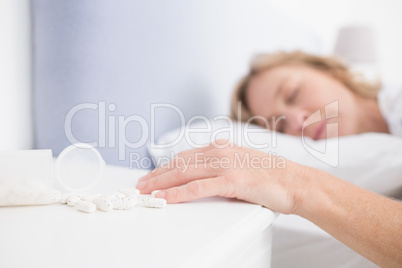 Blonde woman lying motionless after overdose of tablets