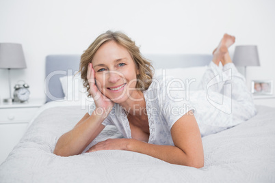 Content blonde woman lying on bed