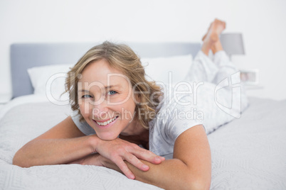 Happy blonde woman lying on bed Happy blonde woman lying on bed