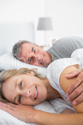 Happy woman smiling at camera with husband