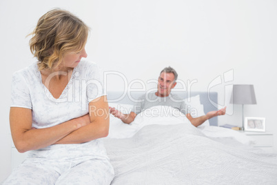 Angry woman looking at husband gesturing during a fight