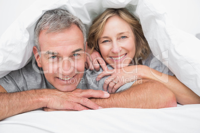 Loving couple under the duvet