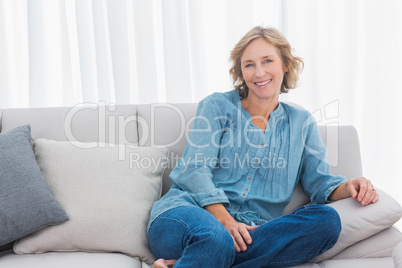 Blonde woman sitting on her couch Blonde woman sitting on her couch