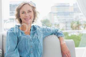Happy woman relaxing on her couch