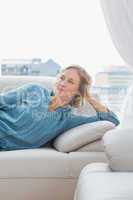 Thoughtful woman relaxing on her couch