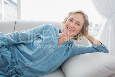 Cheerful woman relaxing on her couch