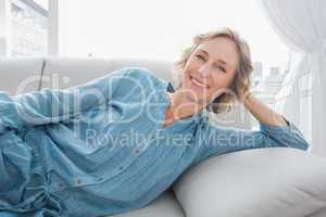 Cheerful woman relaxing on her couch
