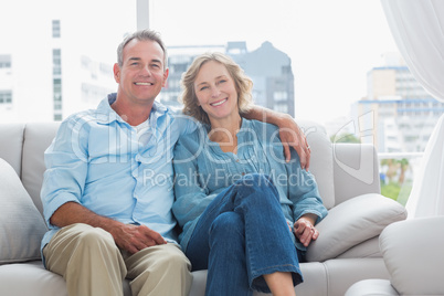 Happy couple relaxing on their couch