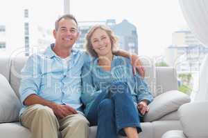 Happy couple relaxing on their couch