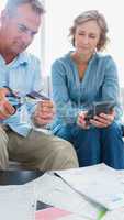 Wife watching her husband cut credit card in half