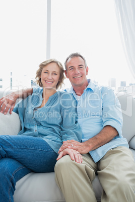 Middle aged couple sitting on the couch