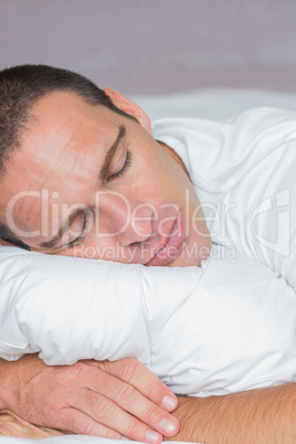 Handsome man sleeping on his pillow